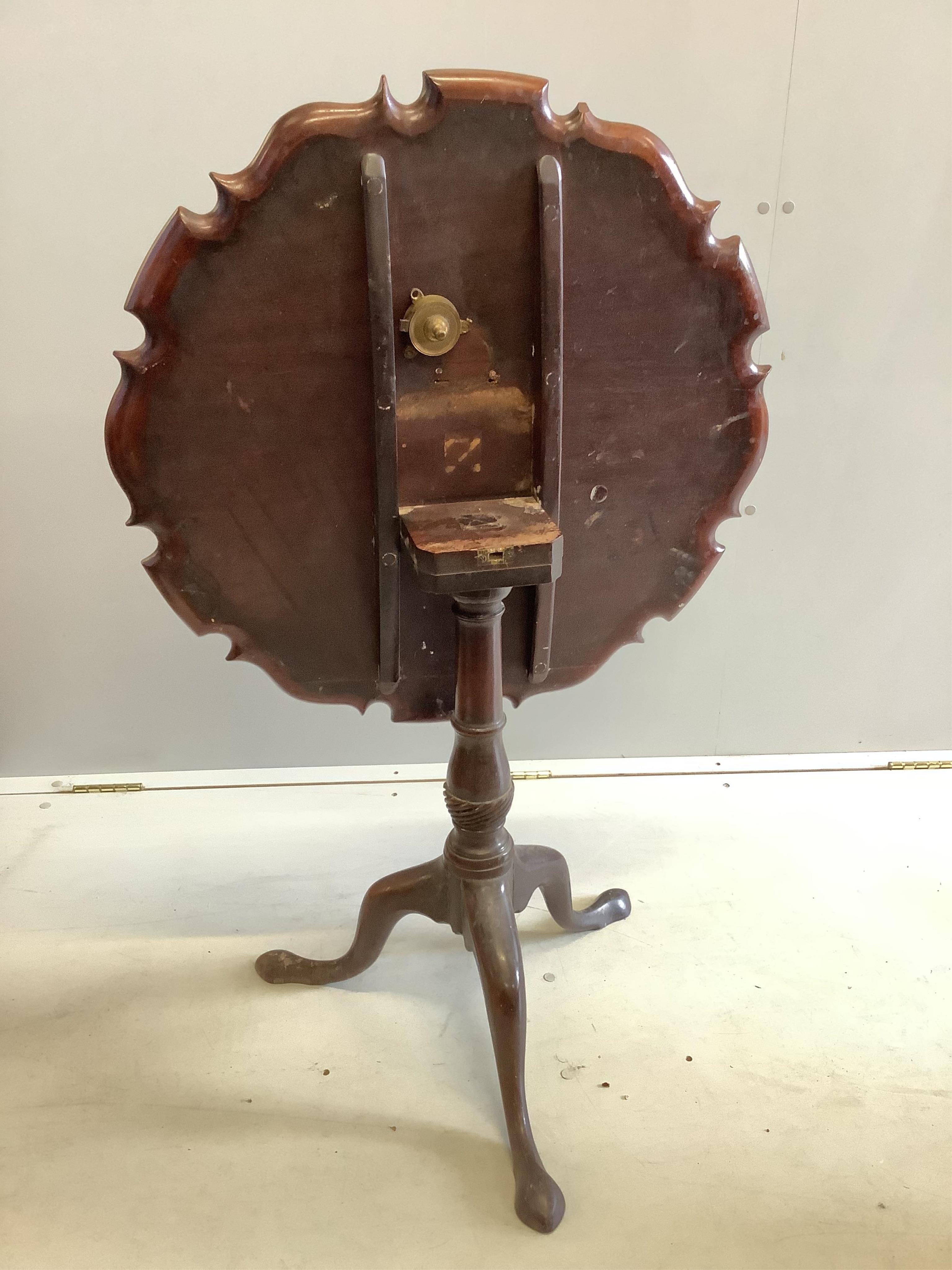 A George III circular mahogany tilt top tea table, diameter 70cm, height 68cm. Condition - fair